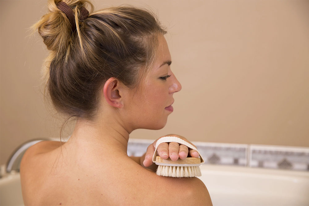 Natural bristle brush used for dry brushing to support lymphatic flow and skin health