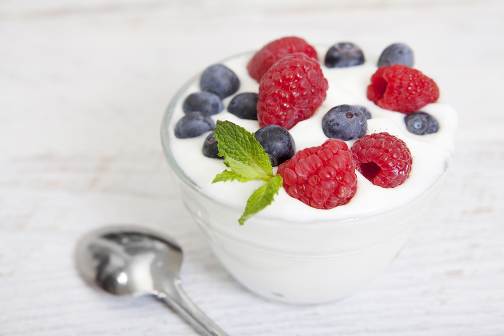 Variety of yogurt options on a table, highlighting differences between healthy and processed types